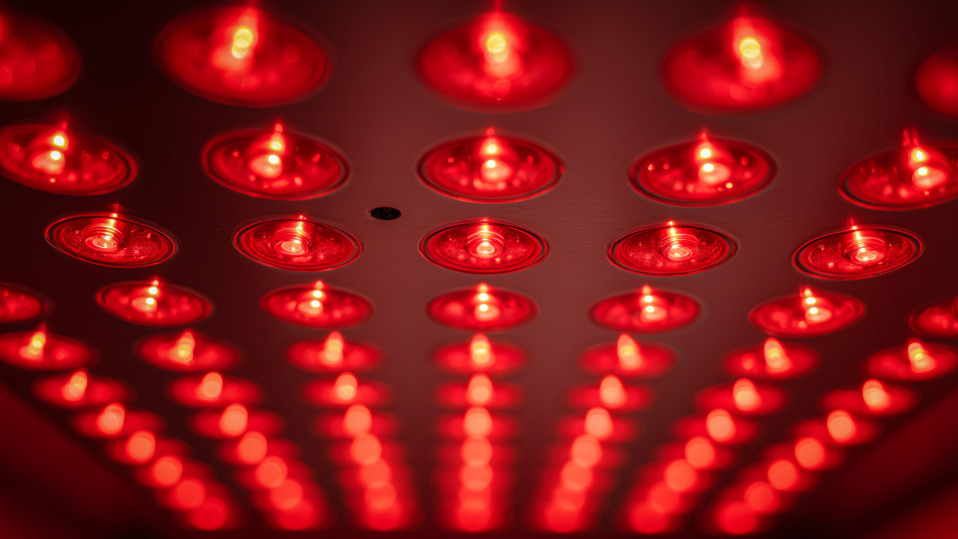 Person relaxing during a full-body red light therapy session